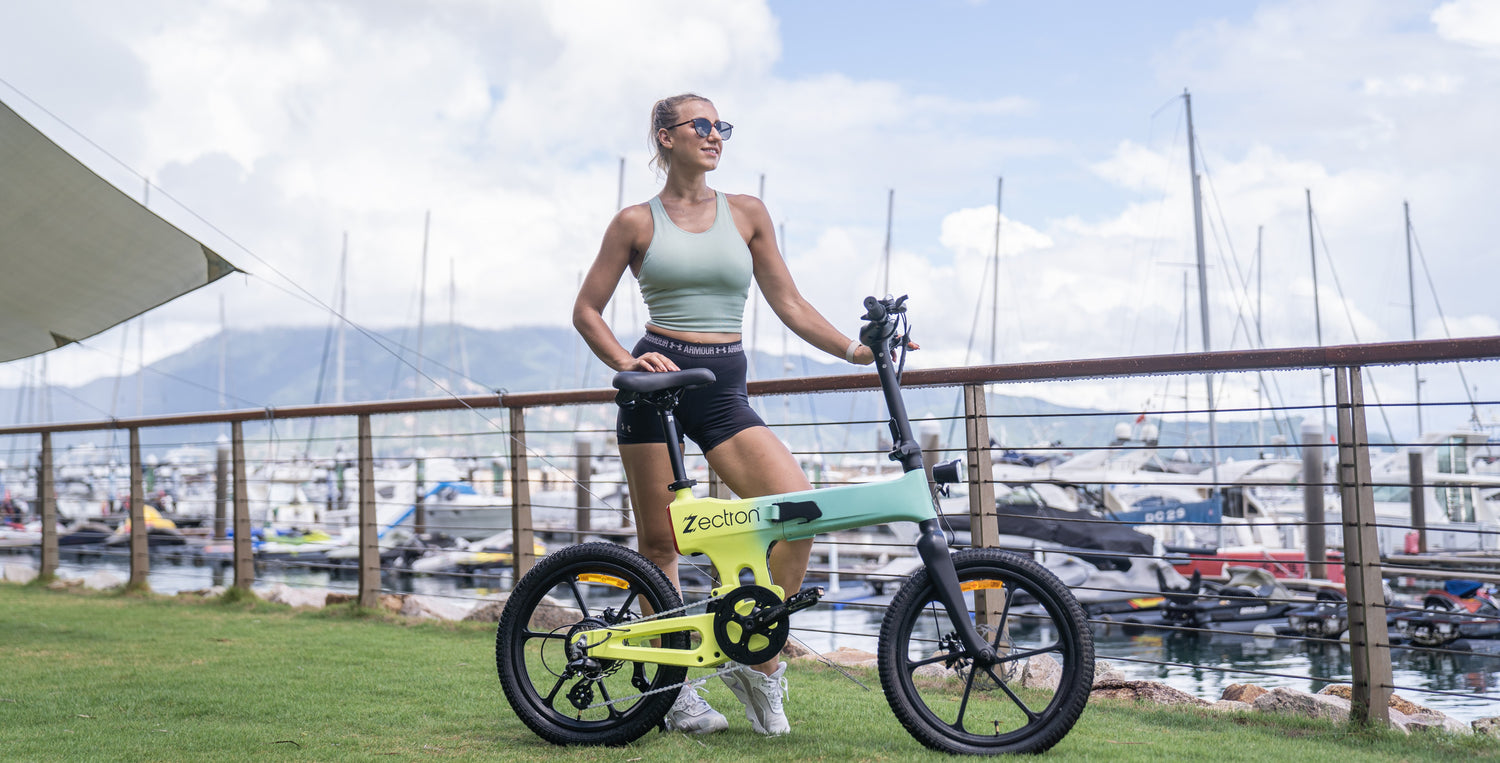 Woman standing with a long range folding Zectron Z1 e-bike